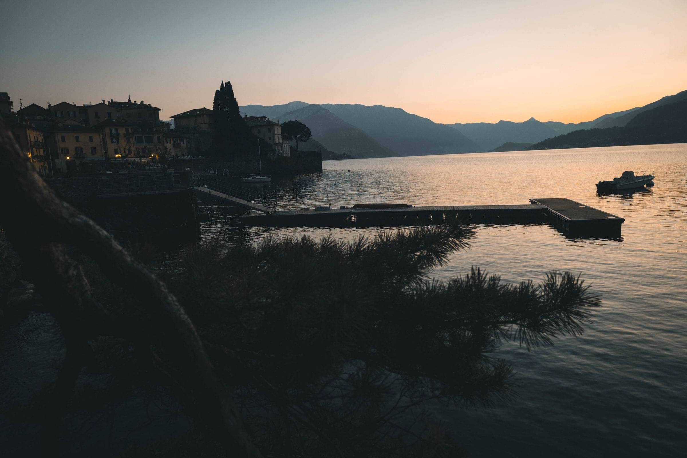 A lake at dusk, a jetty and mooring in the foreground
