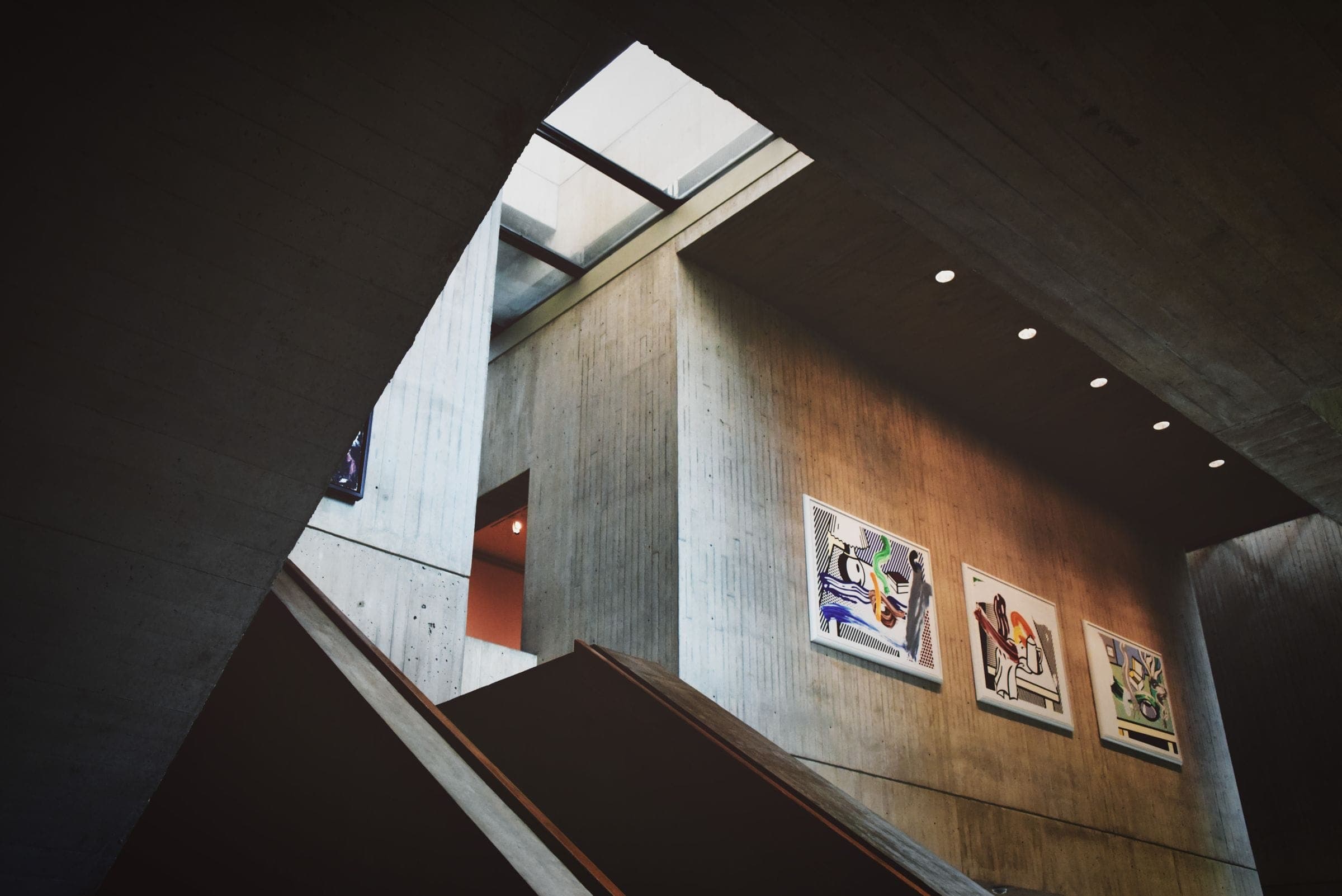 A concrete stair and gallery wall in a spare modern interior