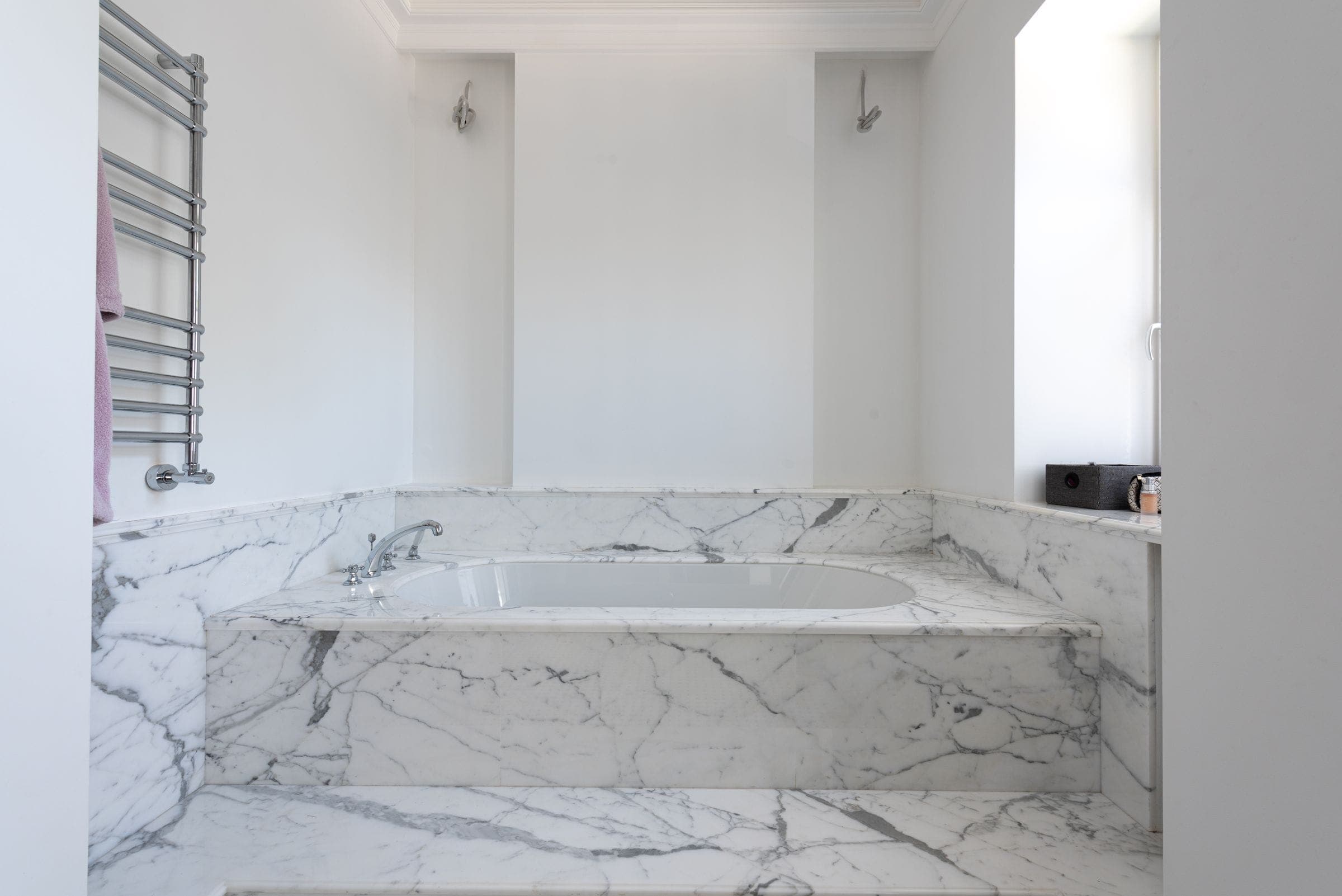 A marble bathing room with clean lines and daylight