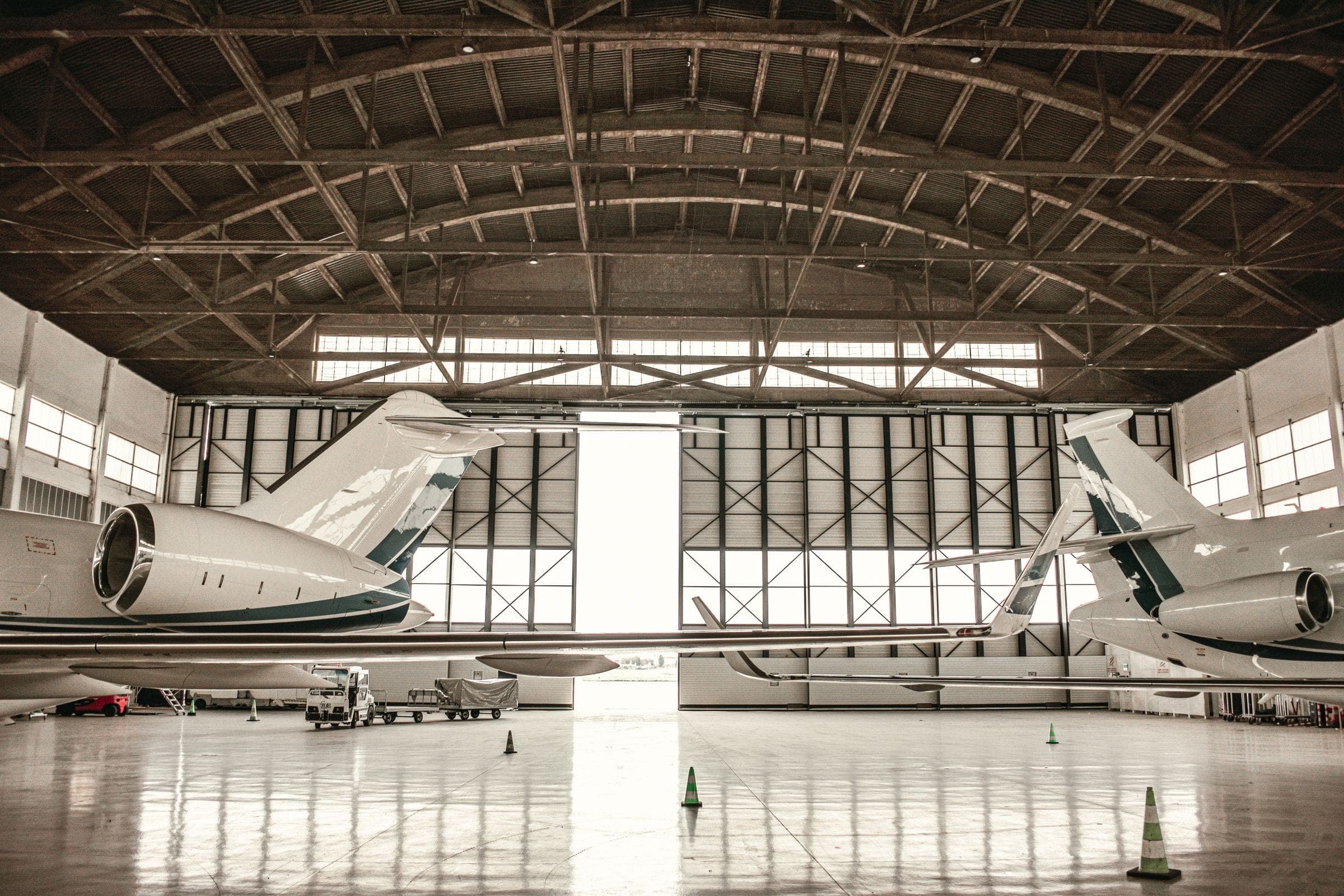 Aircraft inside a daylit hangar, seen from the open hangar door